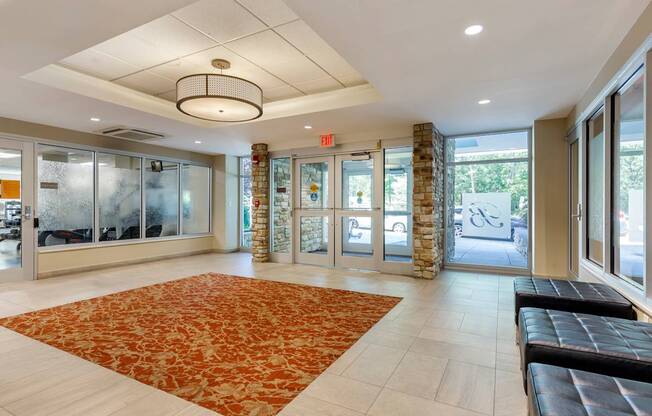 A hallway with a red carpet and a stone pillar.