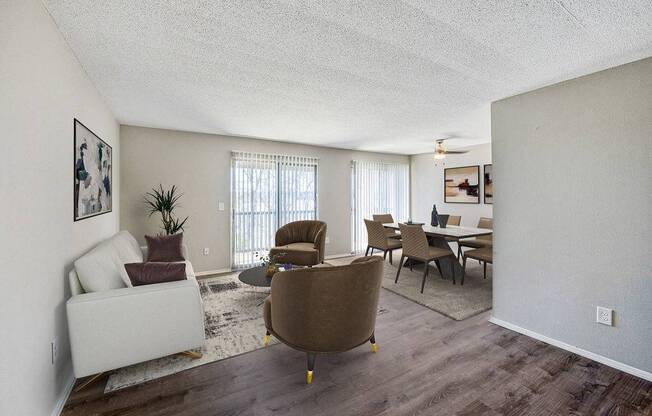 A living room with a brown chair and a white couch.