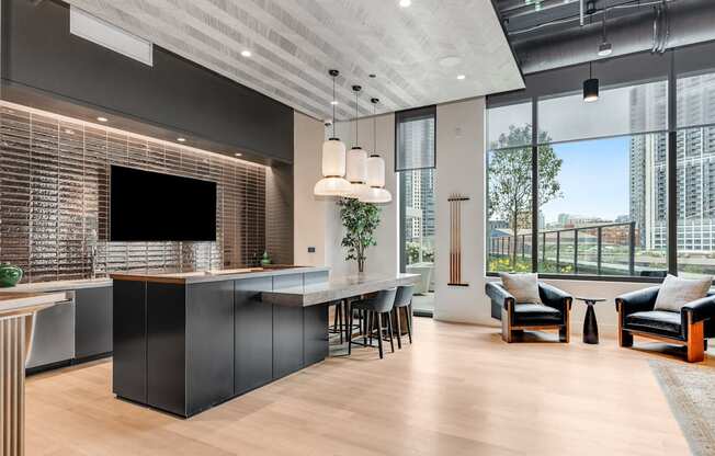 a kitchen and living room with a large window and a tv at Cassidy on Canal, Chicago, Illinois