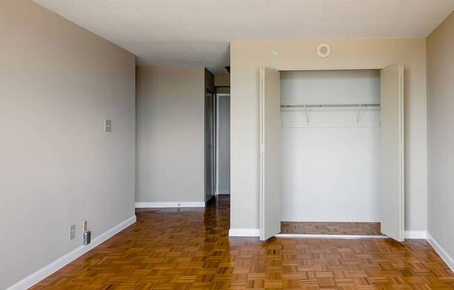 A room with a wooden floor and a white wall.