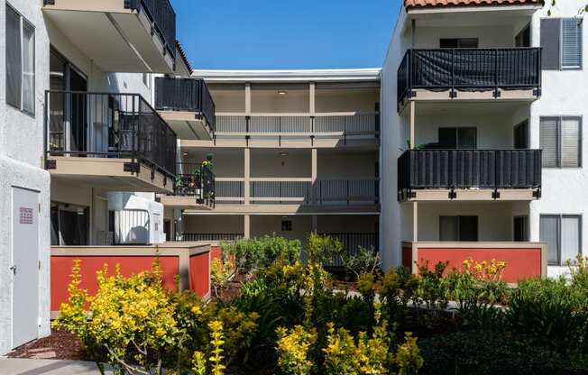 an image of an apartment building with balconies and flowers