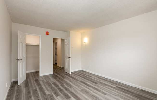 Bedroom with Hardwood Floors and Walk-In Closet