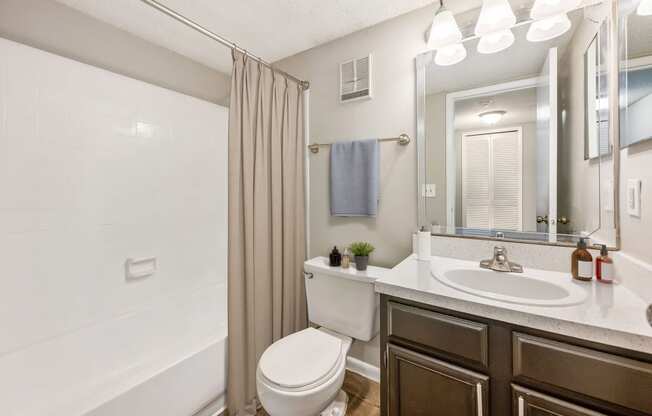 a bathroom with a toilet sink and shower