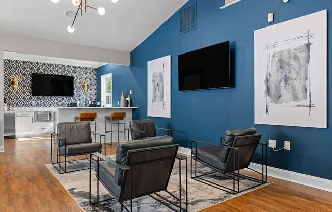 A living room with a blue wall and a television.