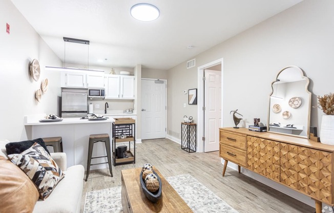 a living room and kitchen with a couch and a table