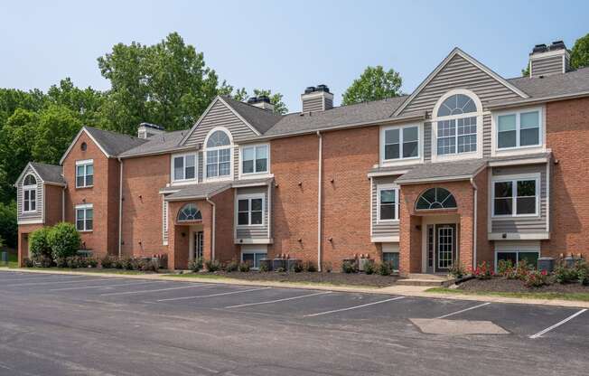 a large brick apartment building with a parking lot