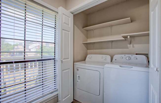 A small laundry room with a washer and dryer.
