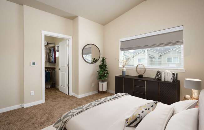 a bedroom with a large bed and a window