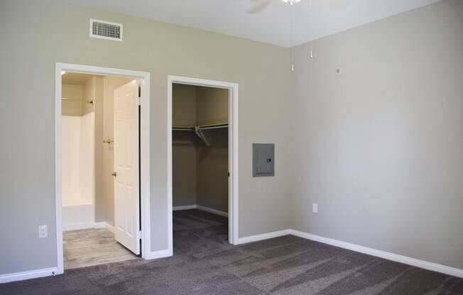 bedroom view looking into closet and attached bathroom