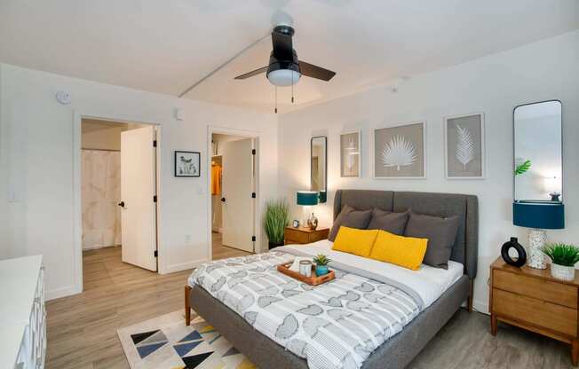 a bedroom with a bed and a ceiling fan at Presidio Palms Apartments, Tucson