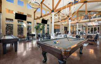 a large clubhouse with a pool table and a ping pong table