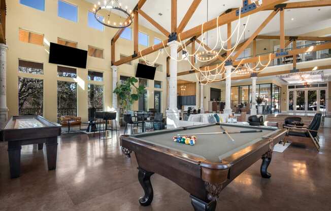 a large clubhouse with a pool table and a ping pong table