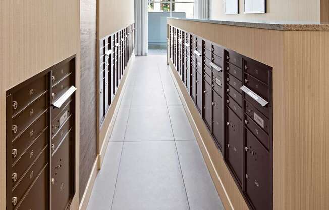 A long hallway with brown drawers on the wall.