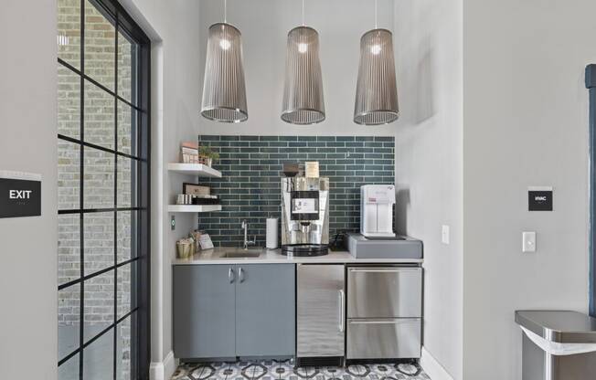 a kitchen with blue cabinets and a coffee maker on the counter