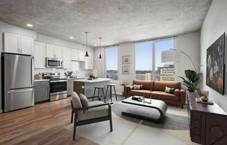 A modern kitchen with a refrigerator, oven, and microwave.