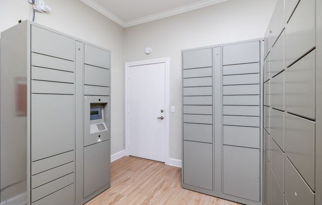 a room with two gray lockers and a white door