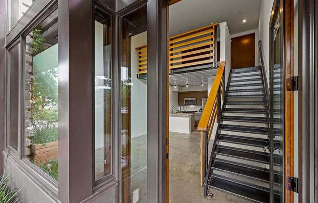 A staircase with a metal railing and wooden handrails.