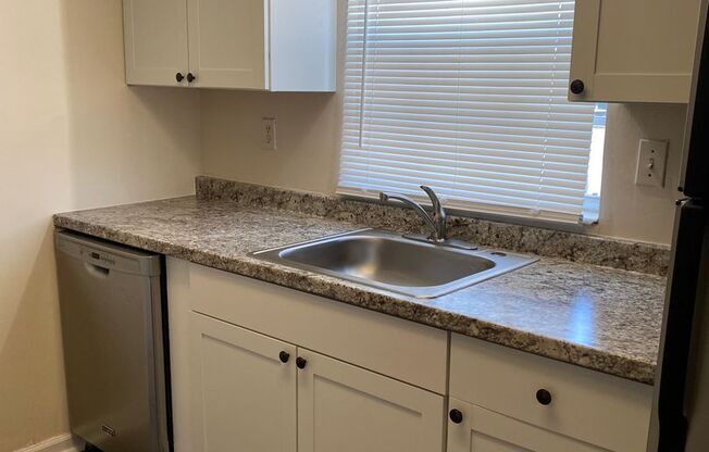 FIRST FLOOR CONDO! UPDATED KITCHEN WITH CABINETS, COUNTERTOPS AND FLOORING!