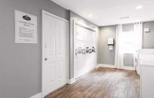 Laundry center rules are posted on the wall.