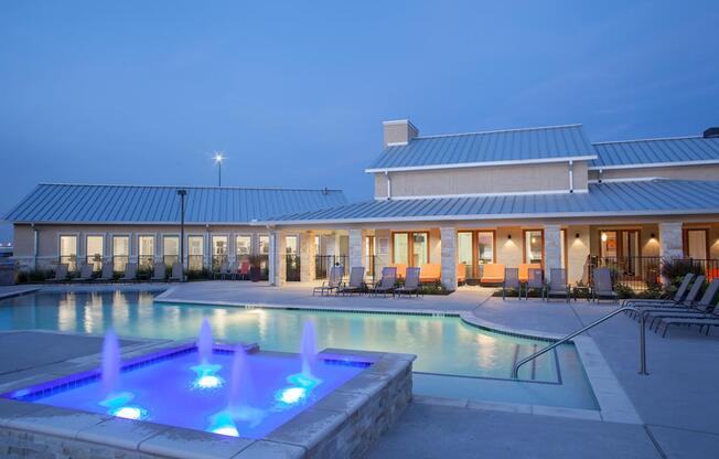 A pool with a fountain in the middle of it.