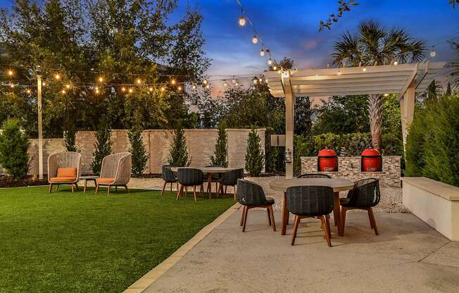 a patio with a table and chairs under a canopy