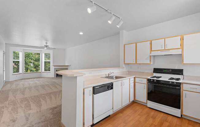 a kitchen with white cabinets and a stove and a sink