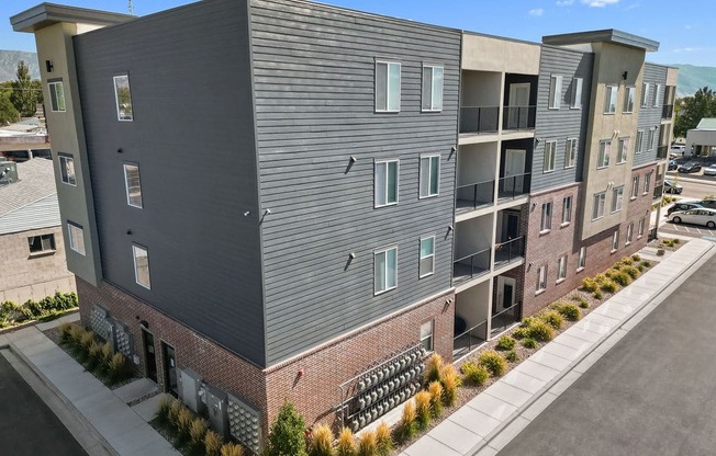 an aerial view of an apartment building with a parking lot