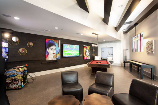 a game room with a pool table and a television