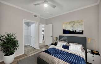 a bedroom with a large bed and a ceiling fan