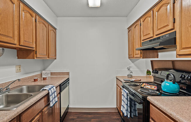 a kitchen with wooden cabinets and a stove top oven