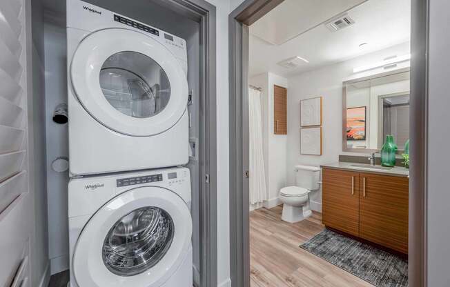A white washing machine and dryer in a laundry room.