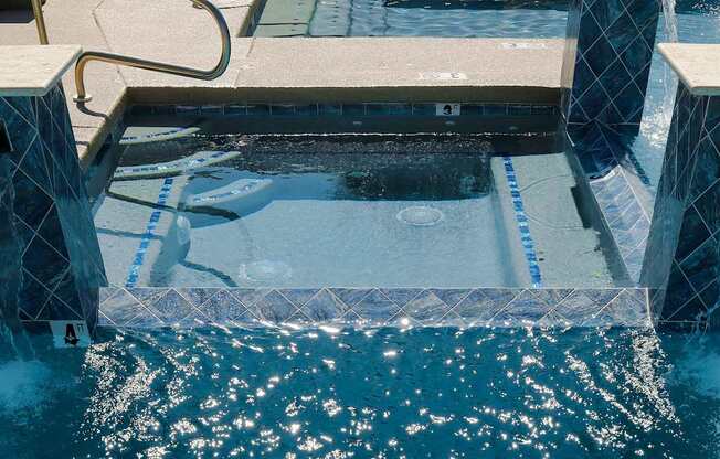 A swimming pool with blue lane markers and a diving board.