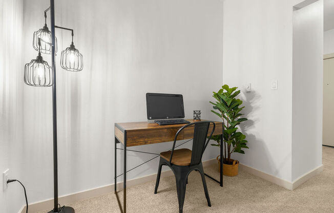 a home office with a laptop computer on a desk