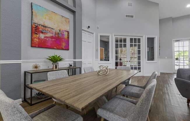 a dining room with a wooden table and chairs