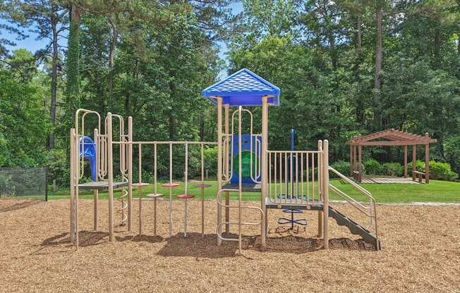 A playground and pergola in the background