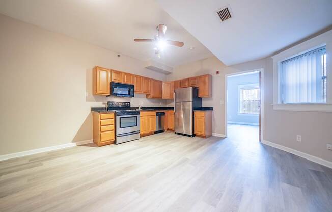 A kitchen with wooden cabinets and a refrigerator.