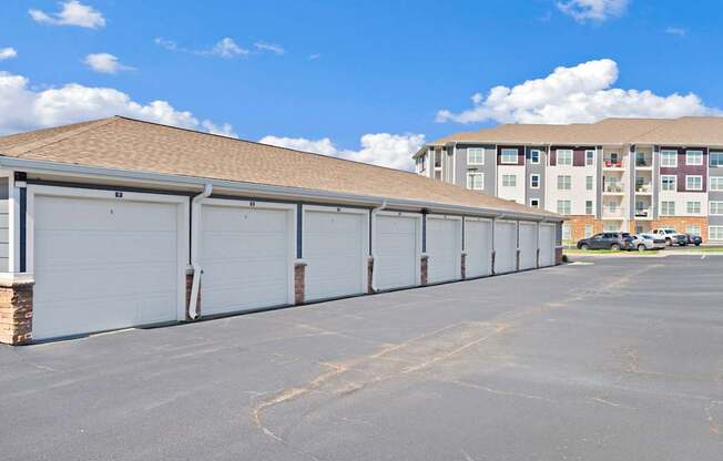 A row of garage doors in front of a building.