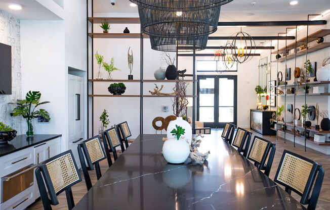 a dining room with a long table and chairs and a large chandelier