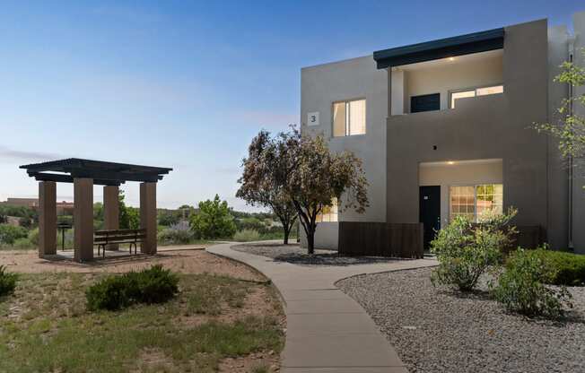 a house with a walkway and a gazebo in front of it