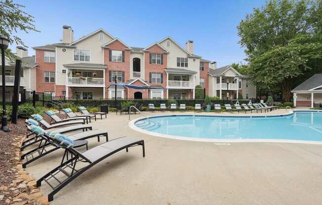 A large building with a pool in front of it.