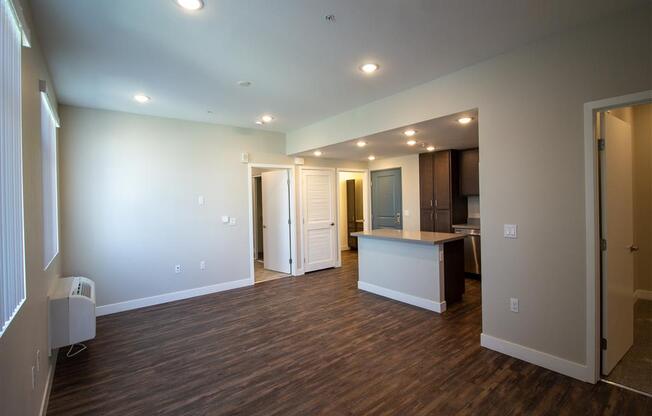 living room with a kitchen in the background at Loma Villas Apartments, San Bernardino, 92408