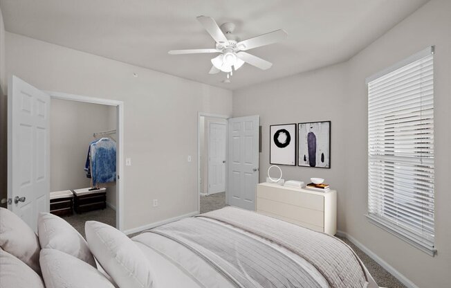 a bedroom with a bed and a ceiling lamp