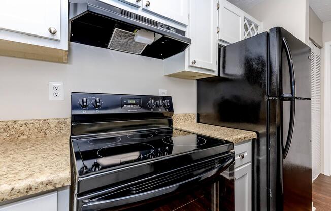 a stove top oven sitting inside of a kitchen