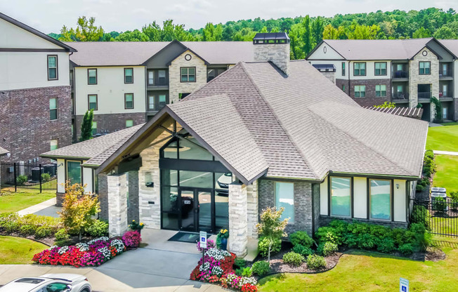 an aerial view of a house with an apartment building in the background