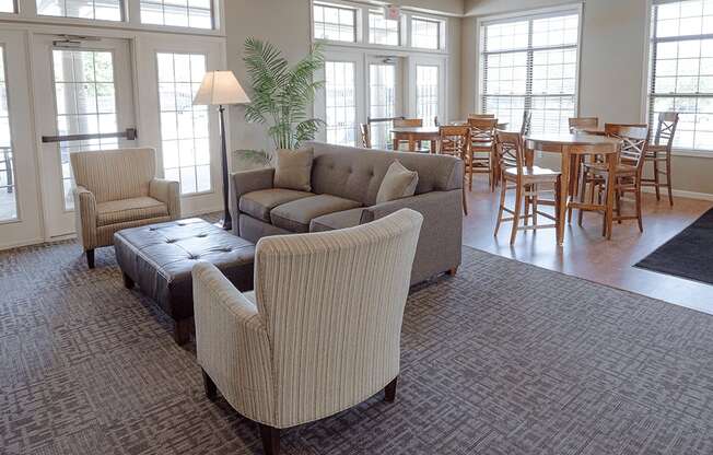 a living room with couches and chairs and a dining room with tables and chairs