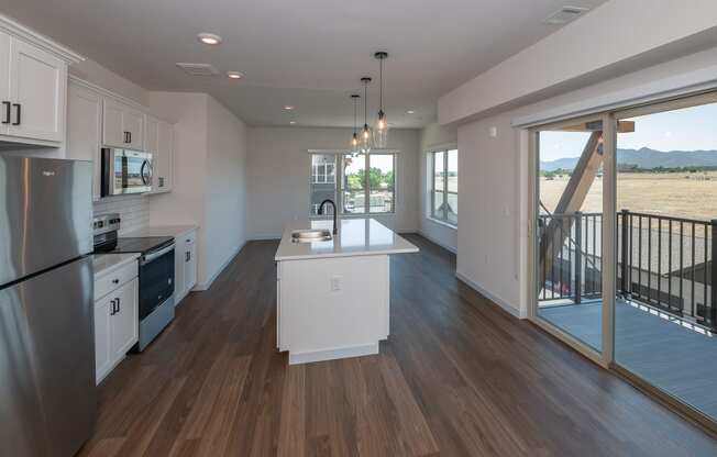 a kitchen with a white counter top and a large window at The Crossings at Windsong, Prescott Valley, AZ