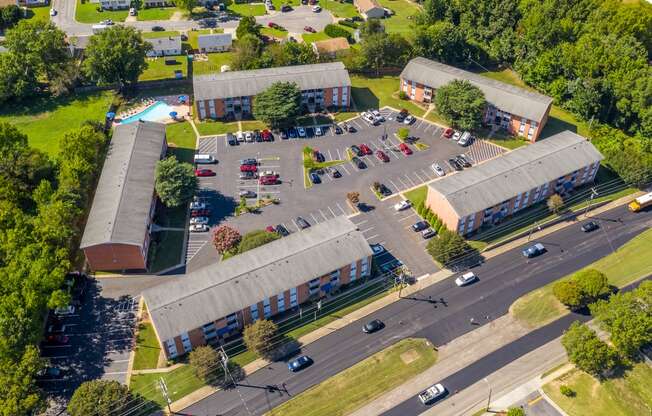 an aerial view of a parking lot and buildings