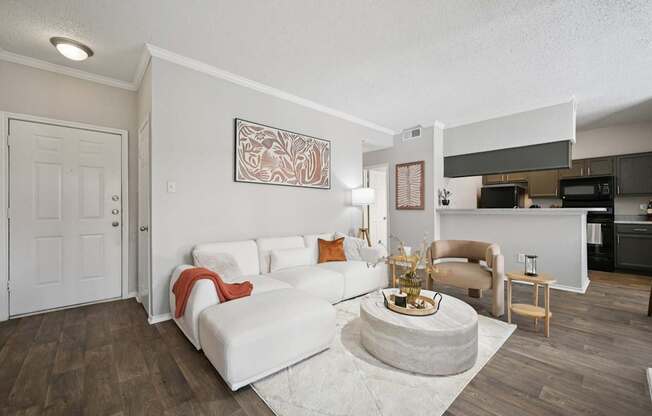 A living room with a white couch and a coffee table.