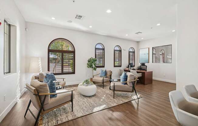 A living room with a brown sofa and a white rug.