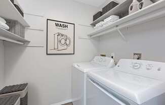 Hinton Height_Cottage Grove_MN_a washer and dryer in a white laundry room with a sign that says